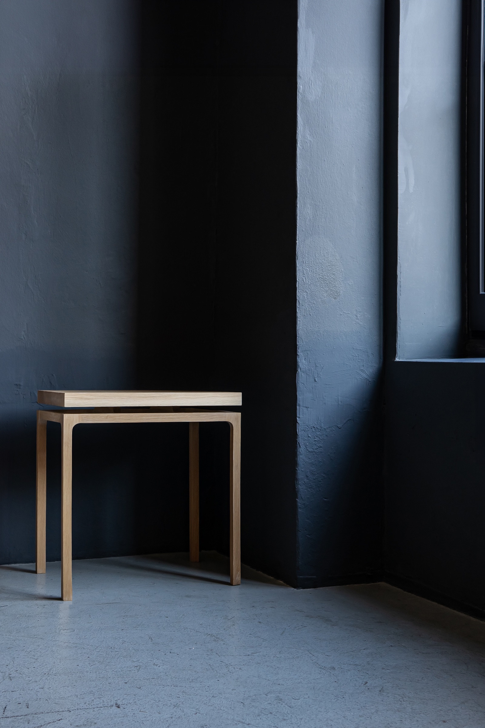 Wooden side table in a dark interior